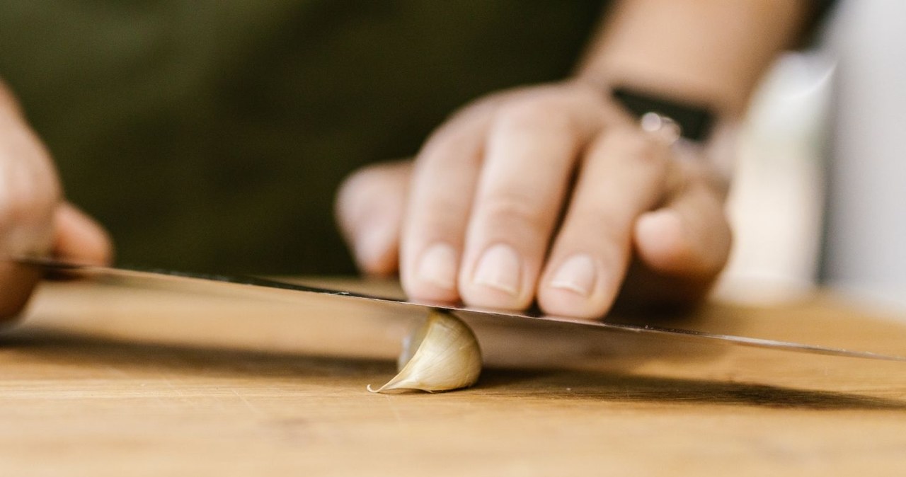 The fastest way to peel garlic is to press it with the flat side of a knife /RDNE Stock project /Canva Pro