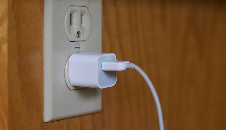 Leaving your charger plugged in all day is a bad idea (for two reasons)