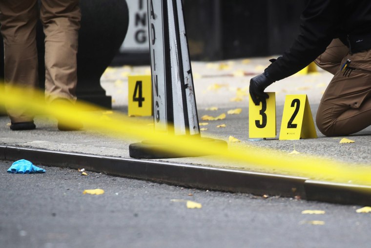 Police place bullet casing markers outside of the Hilton Hotel in Midtown Manhattan where United Healthcare CEO Brian Thompson was fatally shot on Dec. 4, 2024.