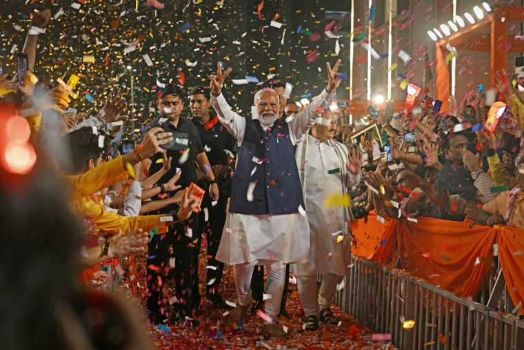 India's Prime Minister Narendra Modi flashes victory signs