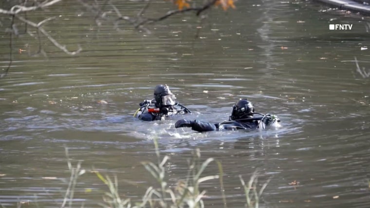 New York police divers search in the area of the Bethesda Fountain in Central Park after they found what is believed to be the gunman's backpack. 