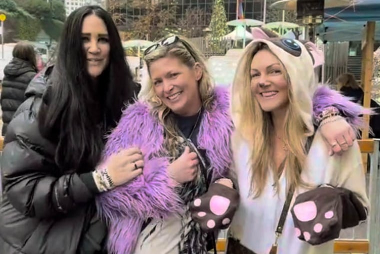 Hope Pinc dressed as Swift's cat as she poses with friends and Elizabeth Sanders and Melissa Peirce.