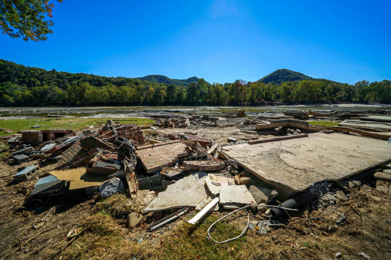 Debris of a house rests by the Nolichucky River.