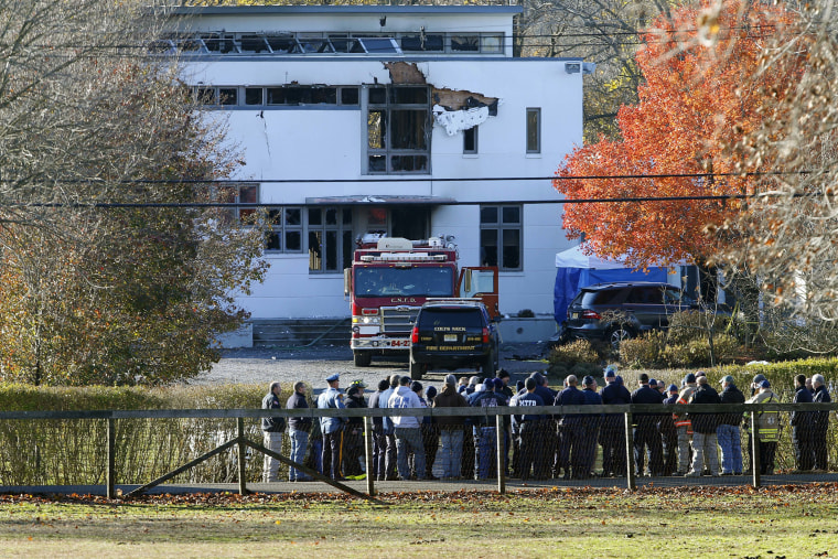 Authorities gather in Colts Neck, N.J., on Nov. 21, 2018, to investigate a fire that killed two children and two adults. The bodies of Keith Caneiro; his wife, Jennifer Caneiro; and their children, Jesse, 11, and Sophia, 8, were found, all victims of apparent homicides. 