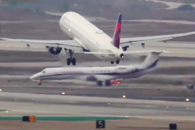 A private jet carrying the Gonzaga University men’s basketball team, bottom, nearly crosses a runway as another flight was taking off at Los Angeles International Airport on Dec. 27, 2024.