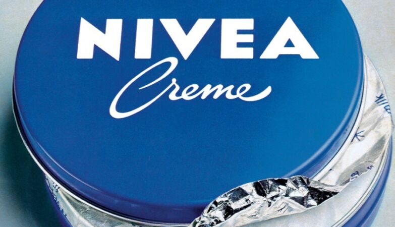 Traditional cream jar from the Nivea brand with blue color and white logo.