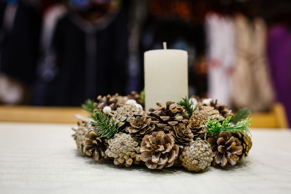 Embellish a candle with pine cones