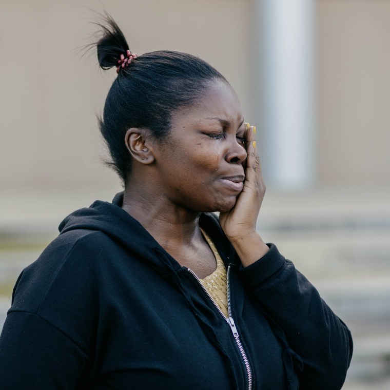 Sherita Harris cries at a news conference.