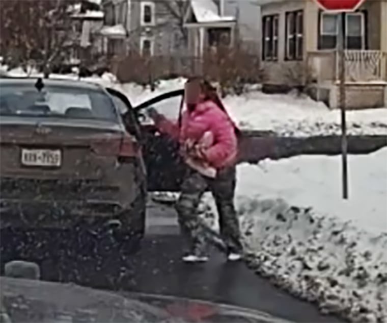 A still from a patrol vehicle’s dashcam shows a female suspect fleeing from a stolen car. Suspect's face obscured by sheriff's office.