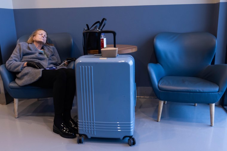 A weary traveler sleeps at Jacksonville International Airport Tuesday morning, January 21, 2025. 