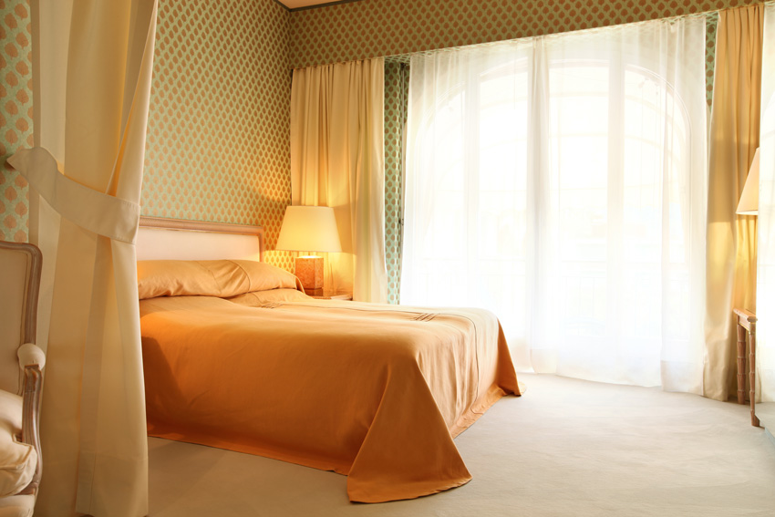 Colored bedroom with yellow and white curtains, modern style.