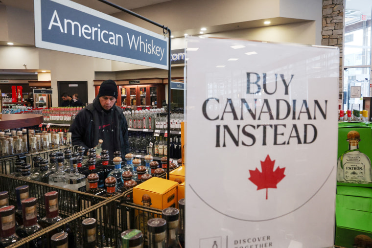 Empty shelves remain with signs ''Buy Canadian Instead'' after the top five U.S. liquor brands were removed from sale at a B.C. Liquor Store, in Vancouver