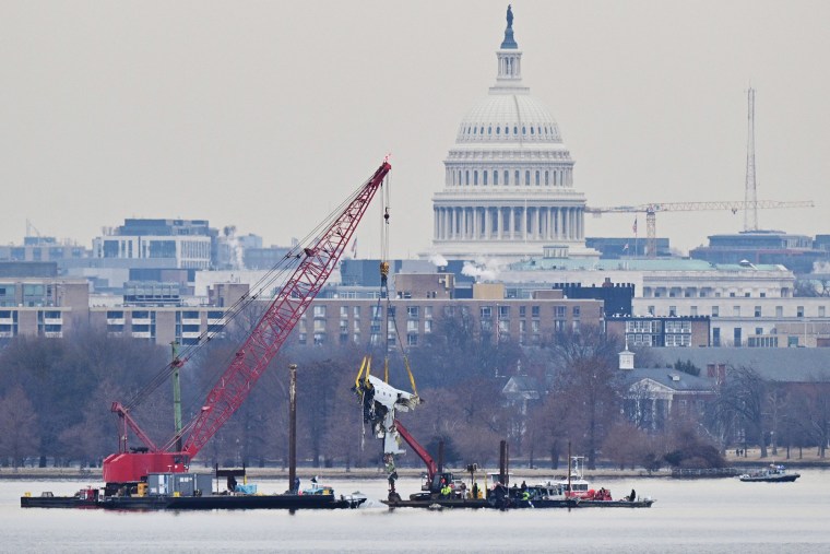 A crane removes airplane wreckage from the Potomac River on Feb. 3, 2025.