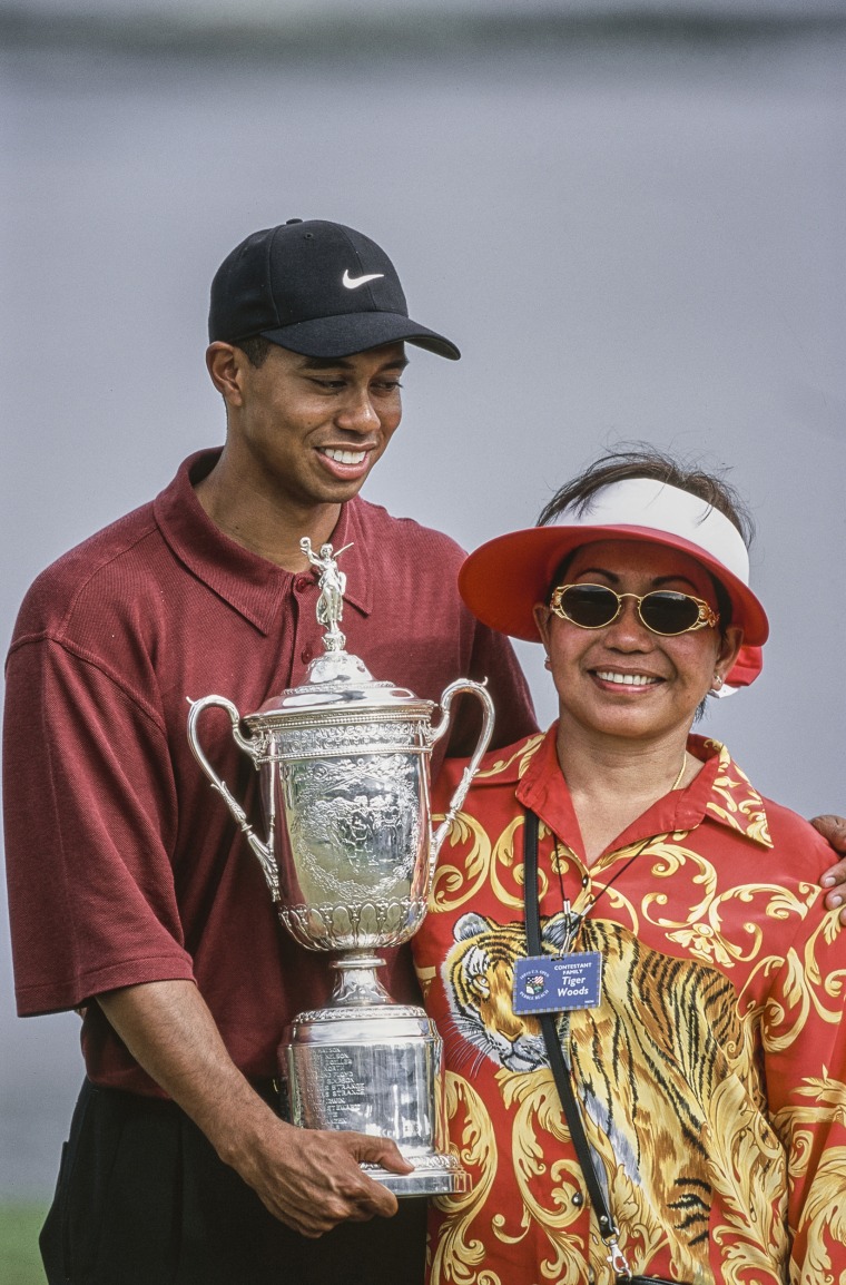 Tiger Woods stands alongside his mother Kultida Woods after winning the 100th United States Open golf tournament in 2000 at the Pebble Beach Golf Links in California.