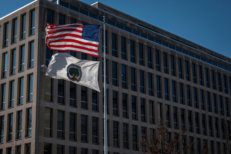 A U.S. flag and an Education Department flag fly.