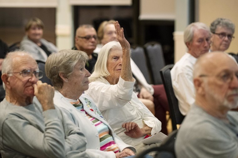 Lillian Guenther raises her hand to ask a question Lt. Eric Calendine speaks about cryptocurrency scams on Feb. 4, 2025, in Bluffton, S.C.