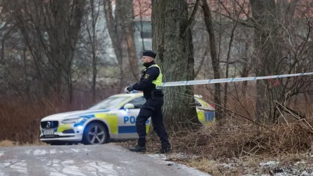 Police officer surrounding area where shooting occurred in Sweden