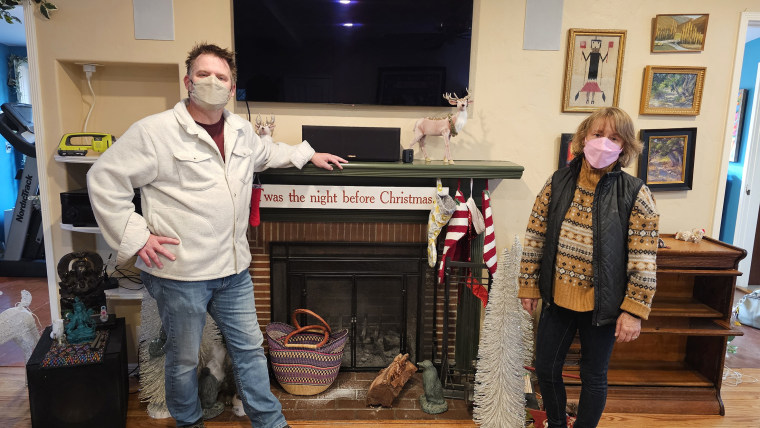 Andrea-Marie Stark and her husband in their smoke-damaged home in Altadena. 