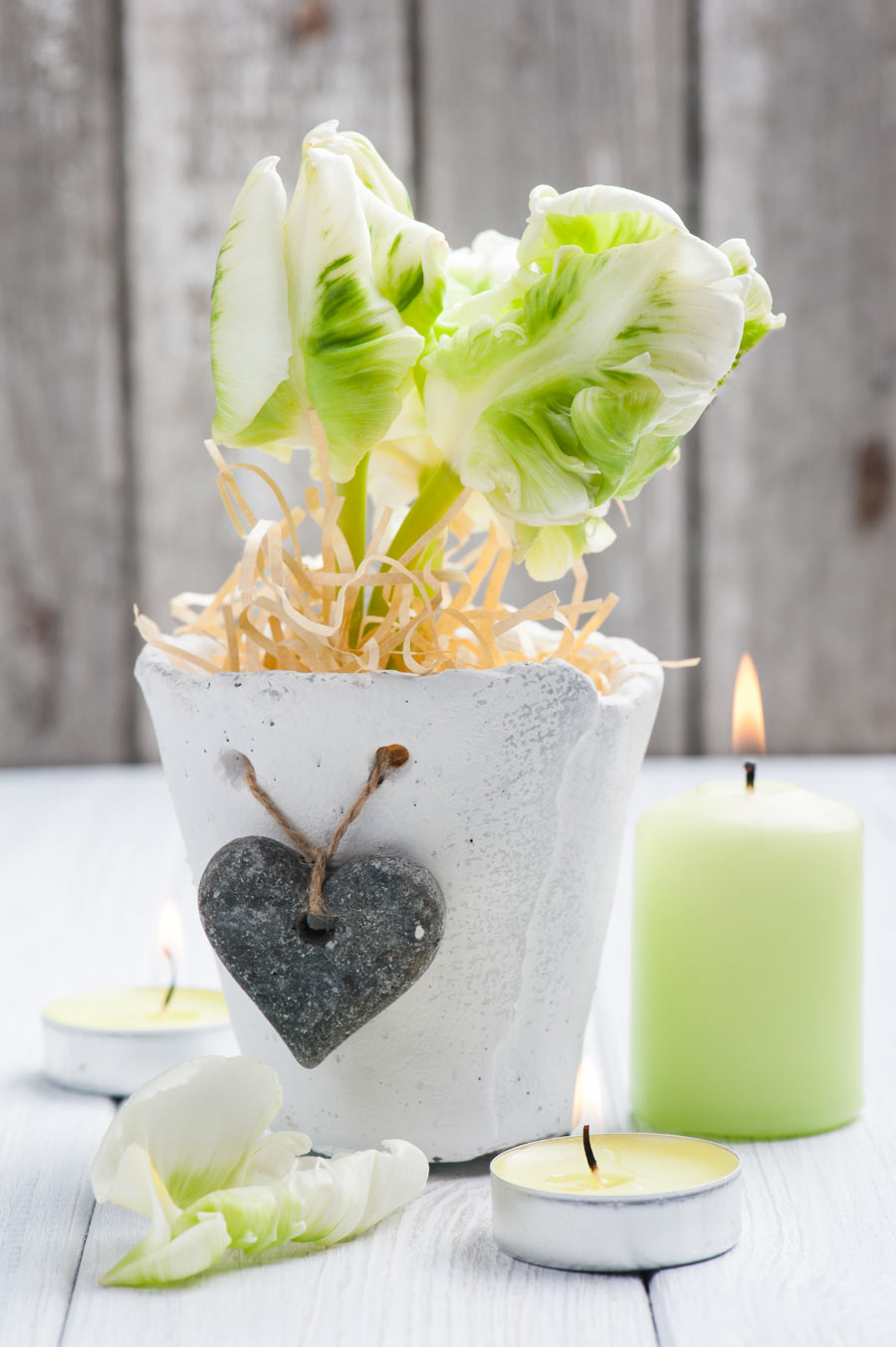 Beautiful jar of white cement with an hanging heart.