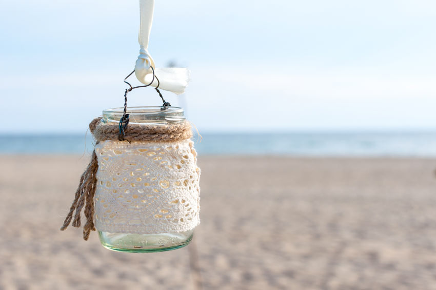 Lantern with glass jar decorated with lace