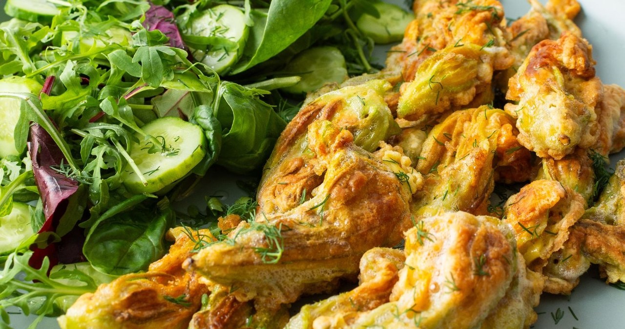 Stuffed zucchini flowers in pancake dough are a delicious and healthy snack /pundapanda /canva pro