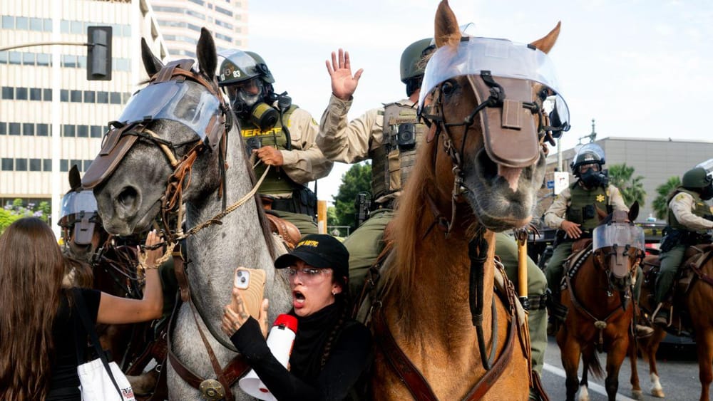 Mounted Police advances on protesters in Los Angeles (Noah Berger/AP)