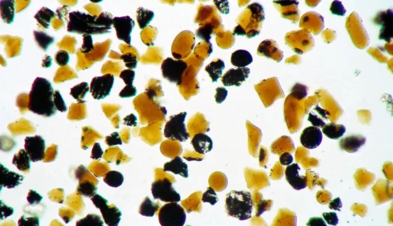 The moon is covered with small orange glass beads. Now we finally know why