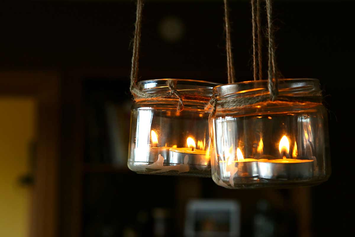 Lanterns suspended with glass jars and candles