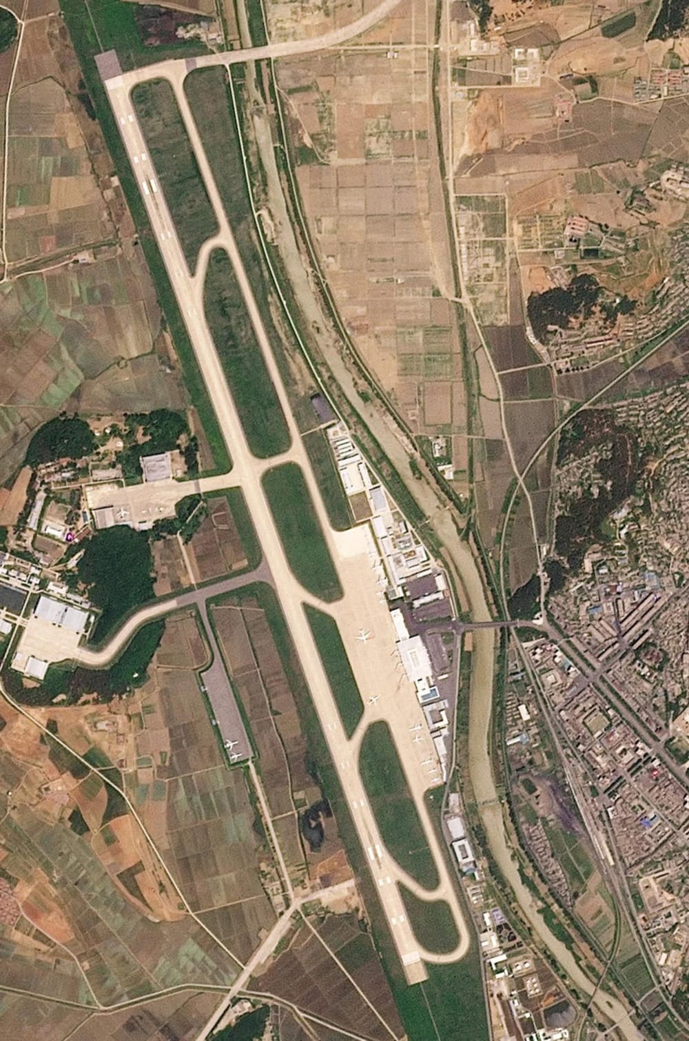 Satellite images from Sunan Airport in North Korea, on June 4, 2025, show what appear to be load aircraft on the track (Planet Labs)