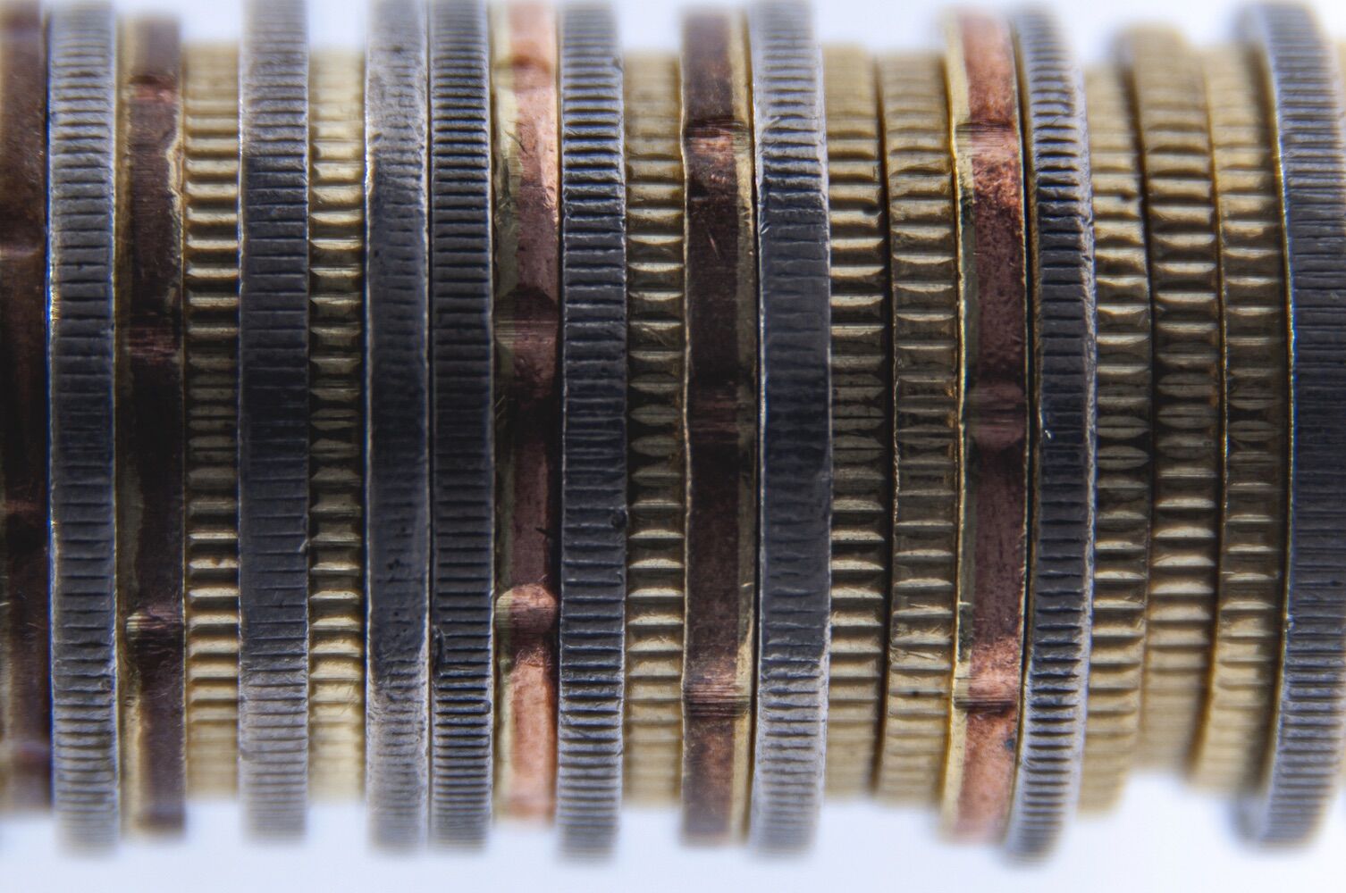Because coins have grooves - and what Newton has to do with it