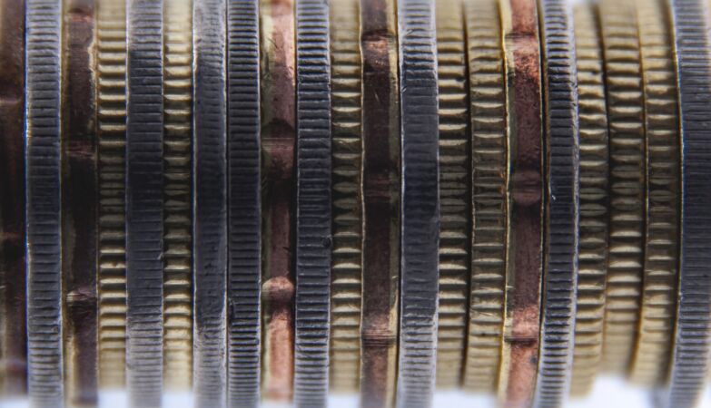 Because coins have grooves - and what Newton has to do with it