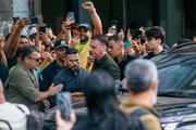 Bolsonaro supporters act in front of the hospital where he performs procedure 