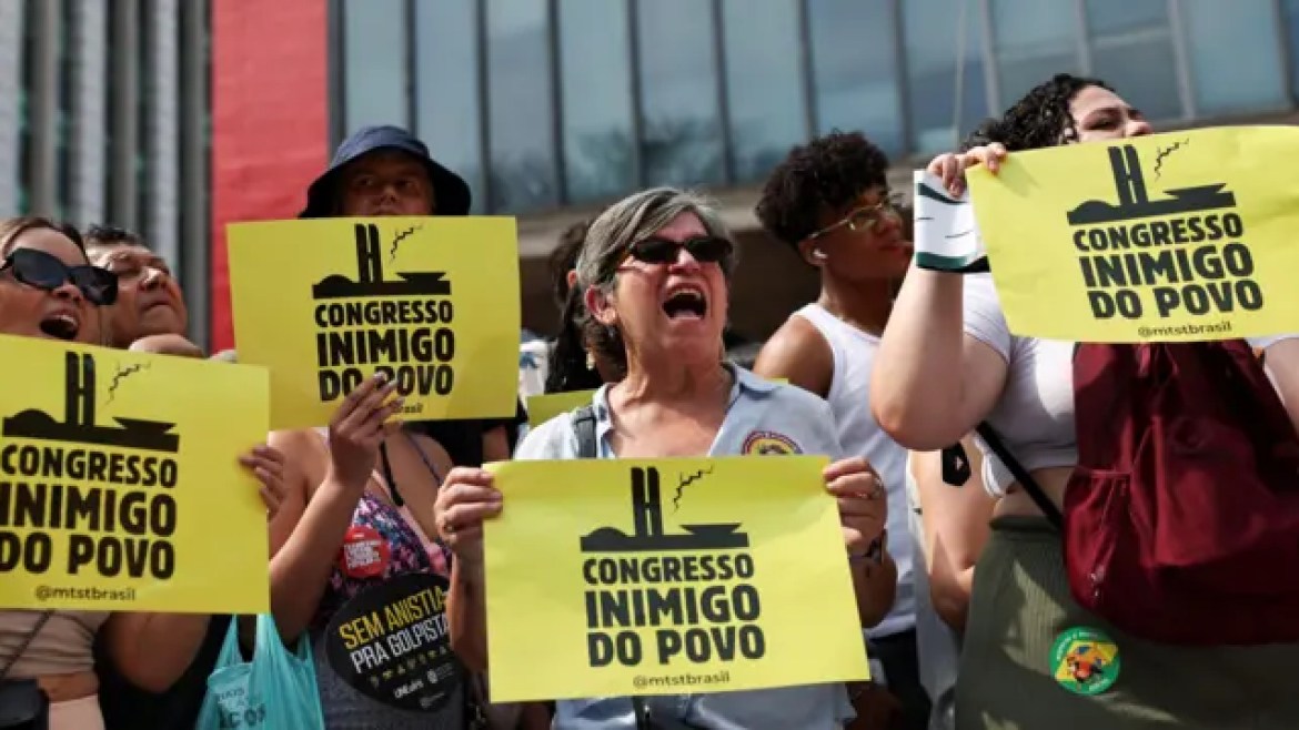 People hold posters with the sayings "Enemy Congress of the People".