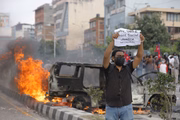 A protester displays posters in challenge during a protest against corruption and the ban on social networks in Catmandu, Nepal, on September 8, 2025.