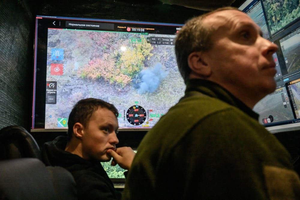 Ukrainian soldiers watch a fatal drone attack on a Russian soldier trying to cross a field north of Izyum, at a drone command center in an undisclosed location in Ukraine, on October 7. (Ed Jones/AFP/Getty Images via CNN Newsource)