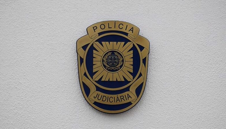 Judiciary Police (PJ) badge on a wall