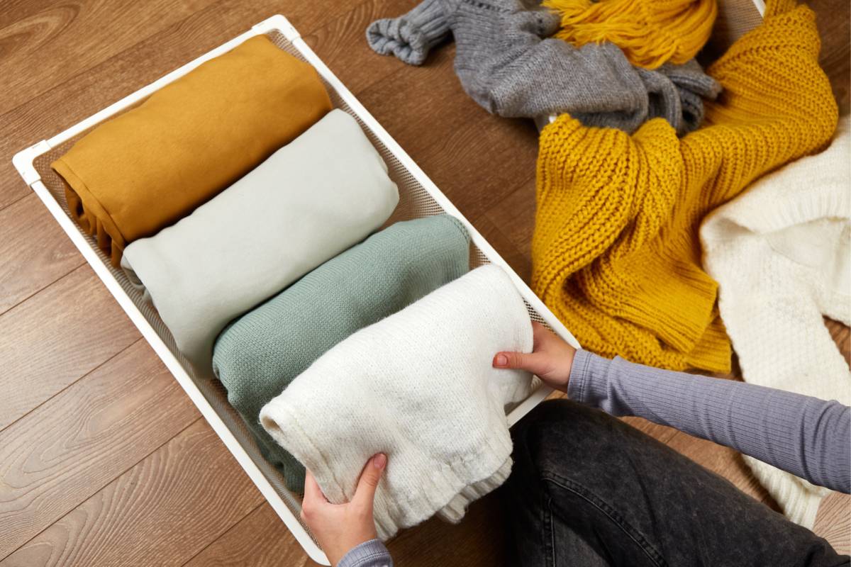 Woman reordering a wardrobe with a container