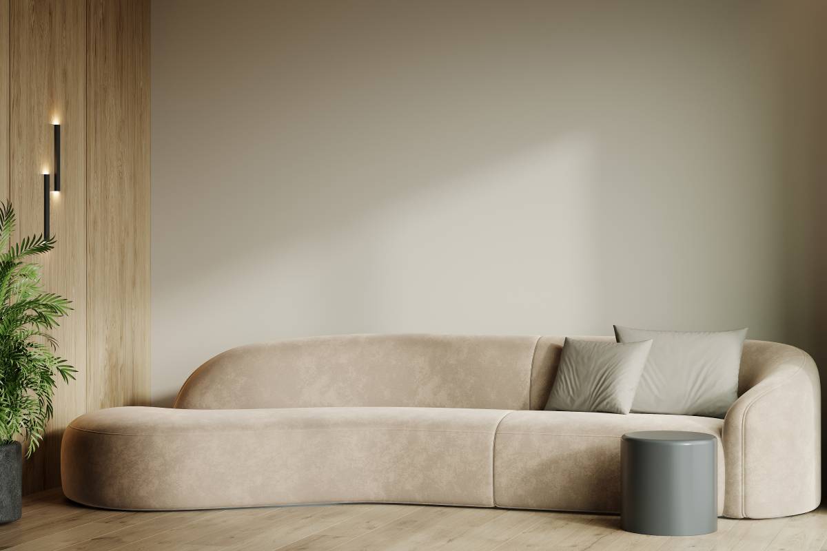 Rope colored sofa on sand wall