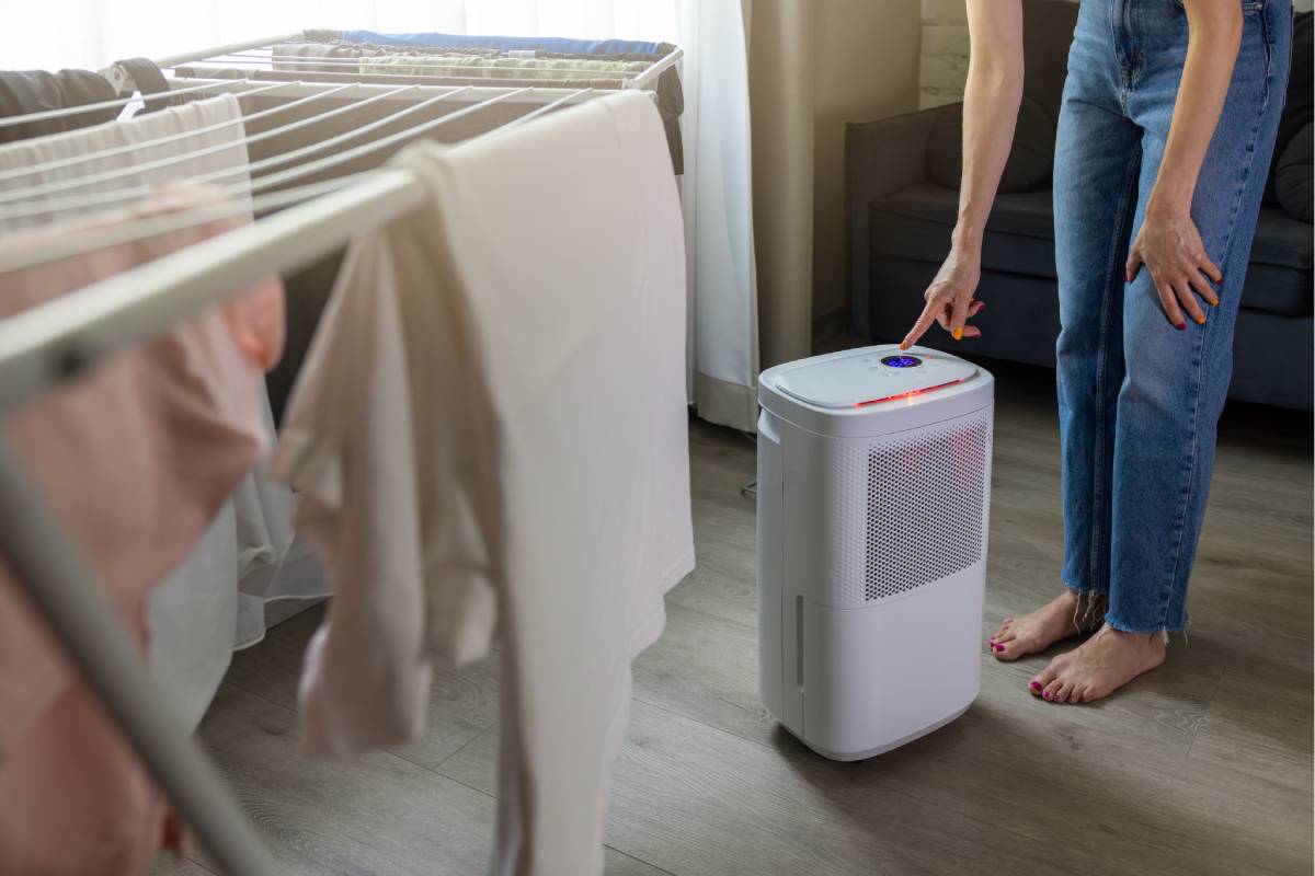 Dehumidifier in a humid room with clothes hanging