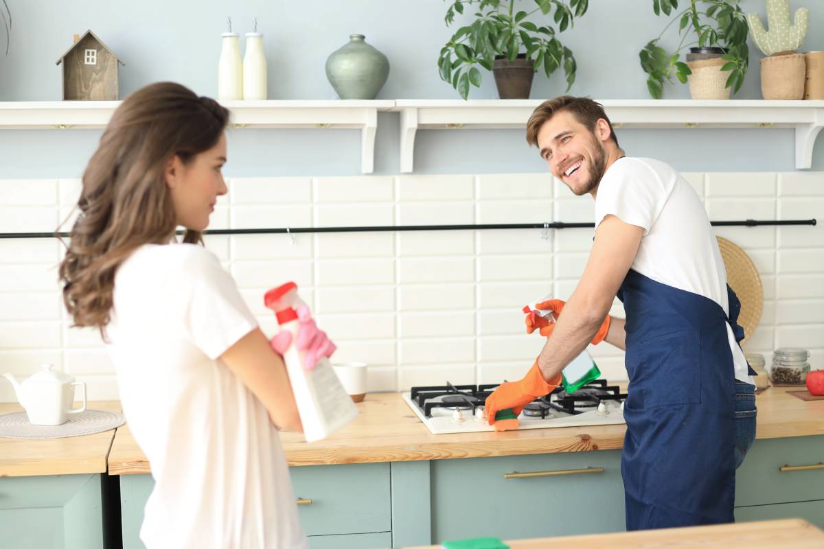 Couple cleaning the kitchen