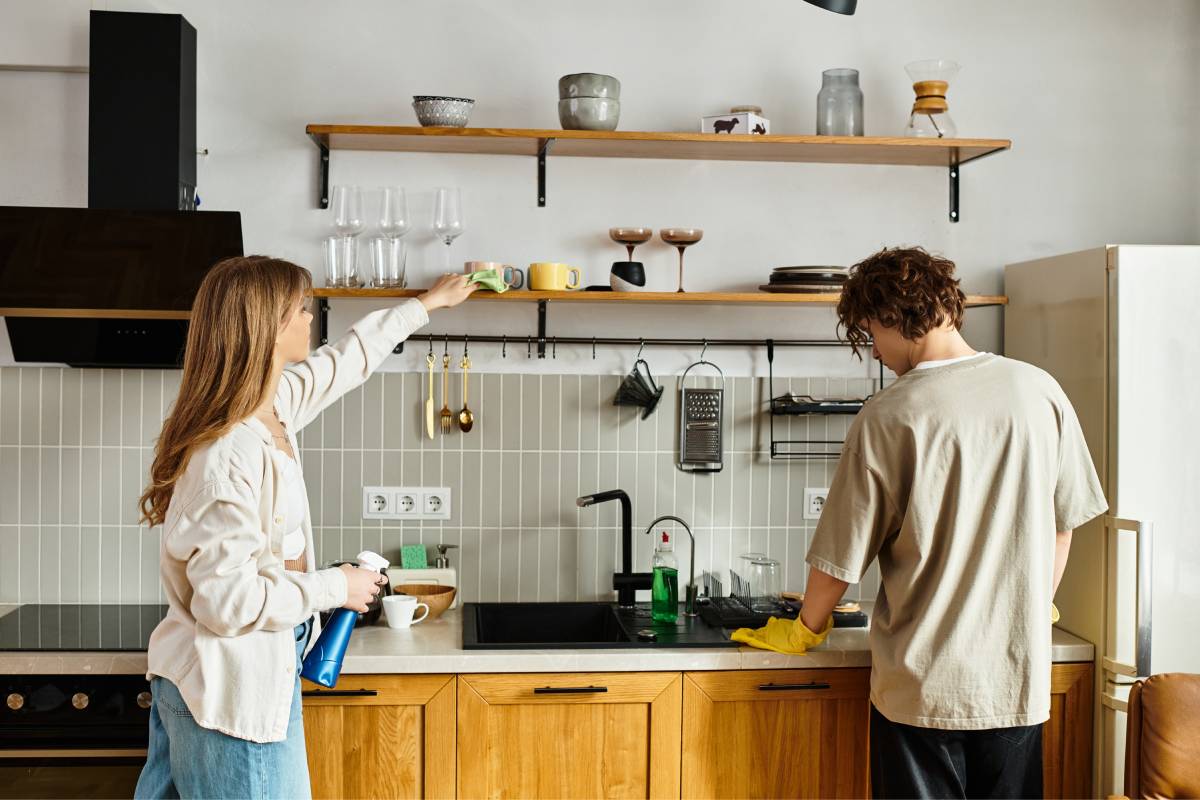 Couple cleaning the kitchen