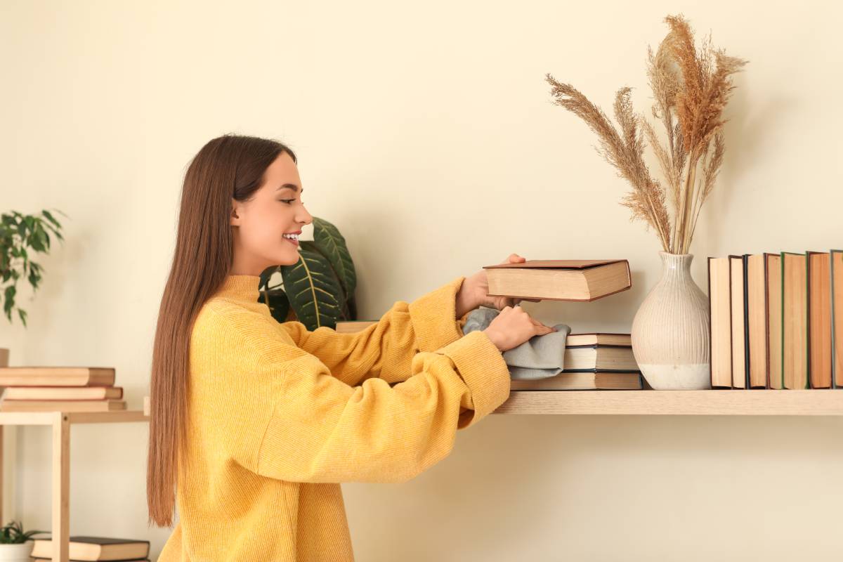 Woman dusting books