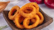 A tasty snack for a party table. Crispy onion rings from the oven