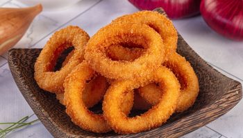 A tasty snack for a party table. Crispy onion rings from the oven