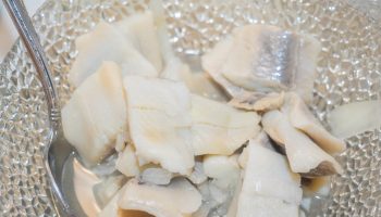 Neither in milk nor in plain water. My grandmother used to soak herrings like this, they had the perfect taste