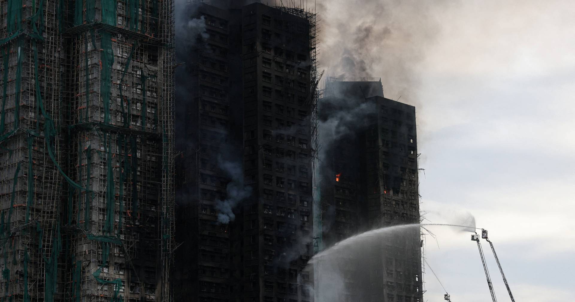 Fire in Hong Kong remains active 24 hours later and people are still trapped