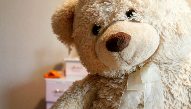 Beige bear plush with a sad look.
