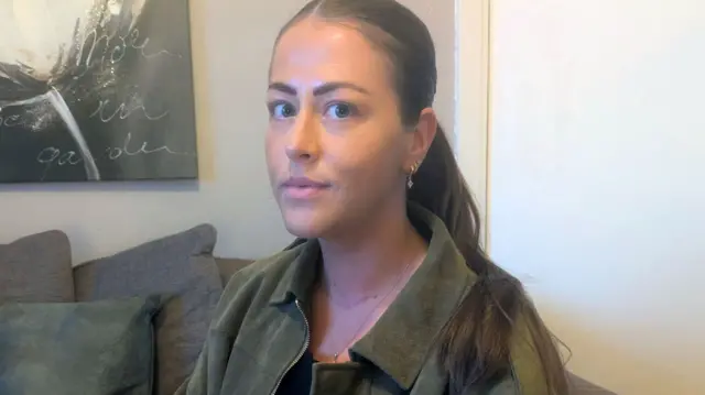 Photo of Nadia in her living room.