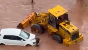 Mother and daughter are stranded in a car during a storm and are rescued on a tractor; see video