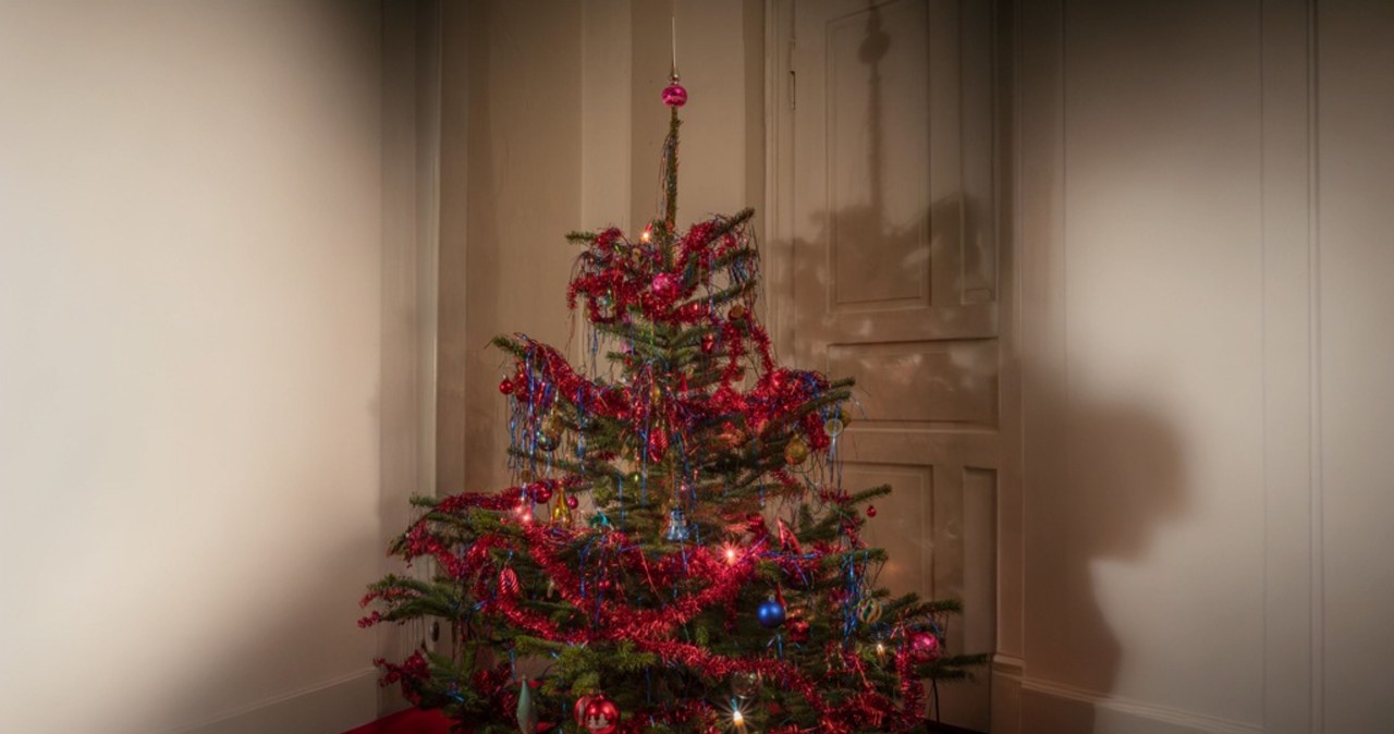 Angel hair on the Christmas tree sparkles with many colors in the light of the lights /Pixel